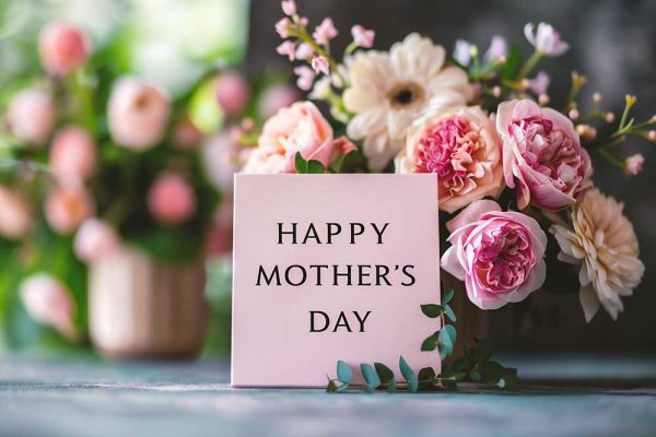 Photo of bouquet of pink flowers with tile that reads happy mother's day.