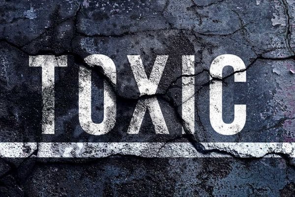 Photo of word TOXIC painted on pavement