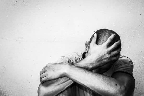 Photo of person holding his head