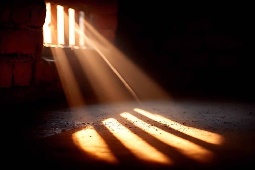 golden-light-beams-shine-through-a-barred-window